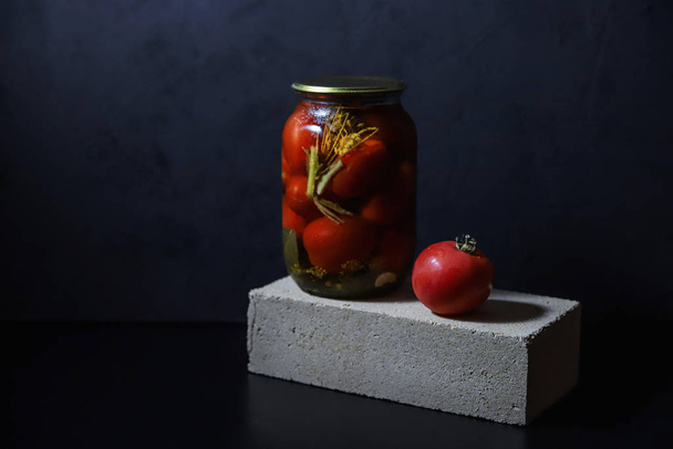 Fermented tomatoes  contemporary food still life. Traditional canned vegetables on dark background. Organic homemade pickles concept. Healthy snacks - Photo, Image