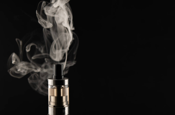 VAPE, electronic cigarette soaring, Smoking on a black background. - Fotoğraf, Görsel