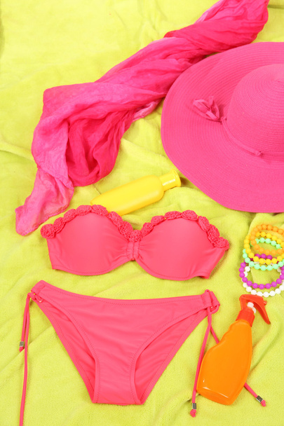 Swimsuit and beach items on bright background - Foto, Bild