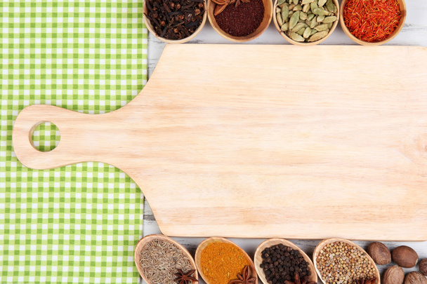 Various spices and herbs with empty wooden board - Foto, Imagem