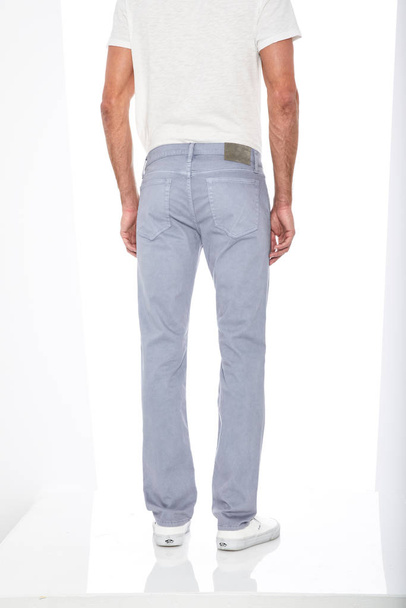 Casual blue denim paired with white casual T-Shirt and white loafers with white background, Basic formal trouser for men’s paired with black casual sneakers and white background - Φωτογραφία, εικόνα