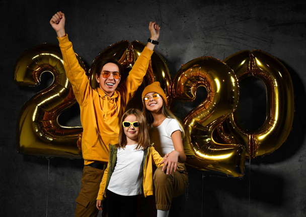 Happy and smiling. Group of beautiful young friends with inflatable numbers celebrating new 2020 year. - Valokuva, kuva