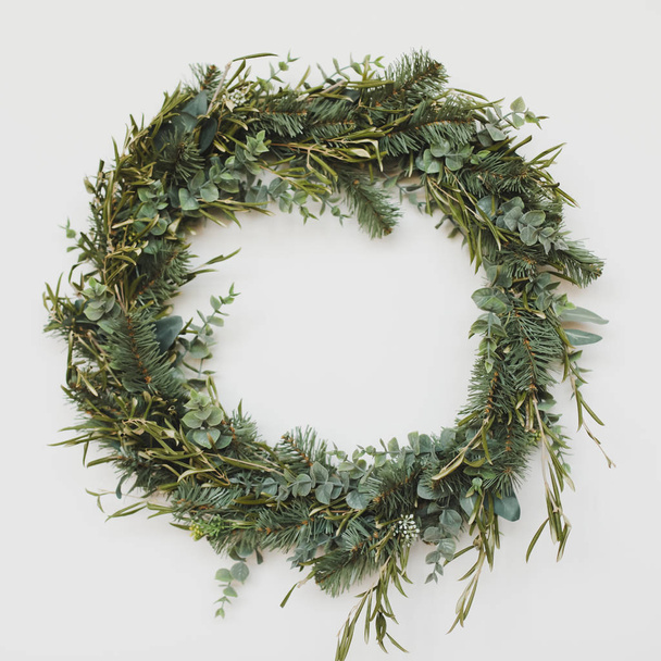 Wreath of spruce. Christmas decorations. Holiday concept. New Year holiday composition. Christmas wreaths in New Year interior. - Photo, image