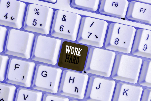 Word writing text Work Hard. Business concept for Laboring that puts effort into doing and completing tasks White pc keyboard with empty note paper above white background key copy space. - Photo, Image