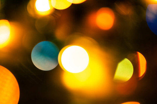New Year abstract pattern with bokeh lights. Christmas background  with blurred colored lights. Holiday background with defocused lights. - Photo, Image