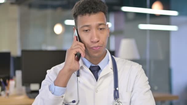 Portrait of Young Doctor Talking on Smartphone in Office  - Materiał filmowy, wideo