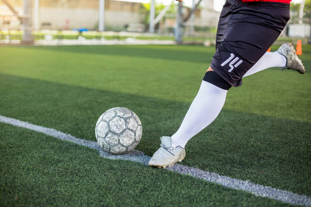 Velocità giocatore di calcio correre per sparare palla a porta sul tappeto erboso artificiale
 - Foto, immagini