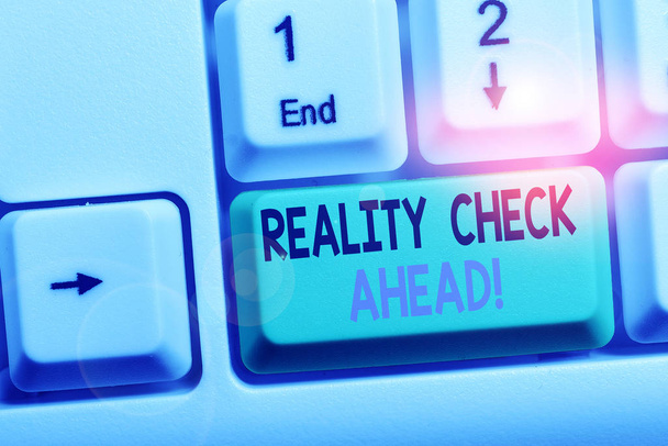 Text sign showing Reality Check Ahead. Conceptual photo makes them recognize truth about situations or difficulties White pc keyboard with empty note paper above white background key copy space. - Photo, Image