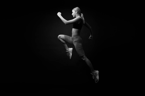 Life is motion. Woman athlete run achieve great result. How run faster. Speed training guide. Improve run speed. Girl runner on black background. Sport lifestyle and health concept. Start run - Foto, Bild