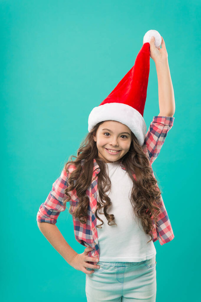 Happy winter holidays. Small girl. Adorable smiling cute baby waiting for Santa. Celebration concept. Pure joy. Winter spirit. New year party. Santa claus fancy kid. Little child in santa hat - Photo, Image