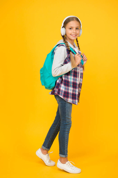 Student. Modern education. Energetic cheerful teen listening music. Stylish schoolgirl going to school. Girl little fashionable girl with backpack. School life. Happy carefree child. School classes - Foto, Imagem