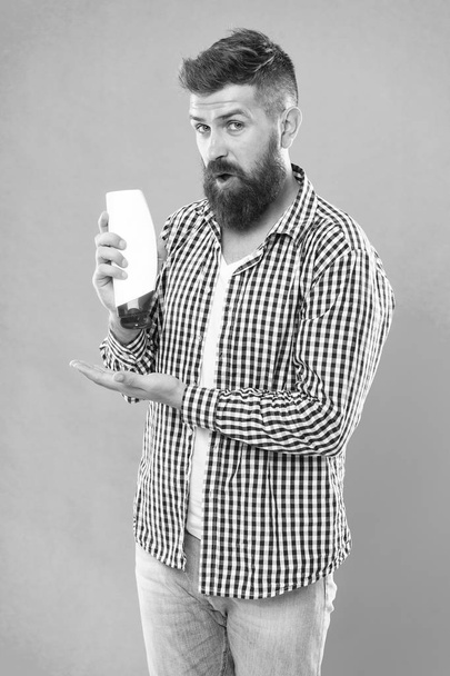 surprised by result. male beauty. self hygiene. good morning. choose this mousse. brutal hipster hold shampoo bottle. Bearded man with healthy hair. Cosmetic for spa bath. beard hair care grooming - 写真・画像