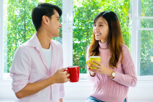 Young couple talking and drink beverage at home - Photo, image
