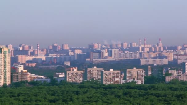 Panorama of city with houses among trees and industrial tubes - Filmagem, Vídeo