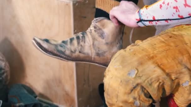 Výcvik rytířů - muž si před obutím obutých bot nasadí ochranu na nohy - Záběry, video
