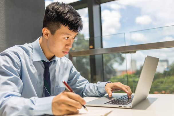 Asian businessman working on laptop in the office - Valokuva, kuva
