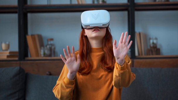 teenage girl in vr headset gesturing with hands - Πλάνα, βίντεο