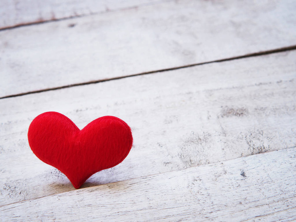 Close up soft red heart shape on white old wood background. - 写真・画像