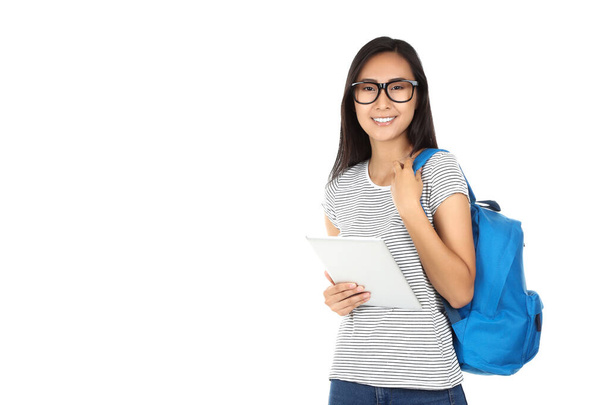 Beautiful young woman holding tablet pc and backpack on white background - Foto, Imagen