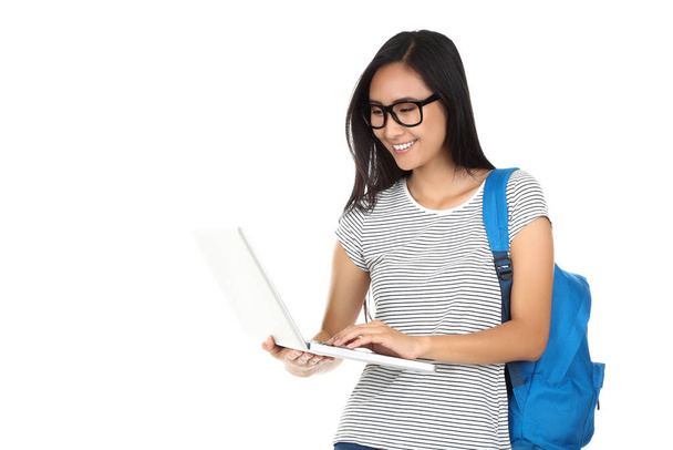 Gyönyörű fiatal nő laptop számítógép és hátizsák fehér háttér - Fotó, kép