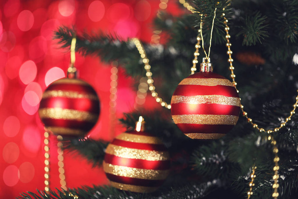 Christmas fir tree with ornaments on blurred lights background - Фото, зображення
