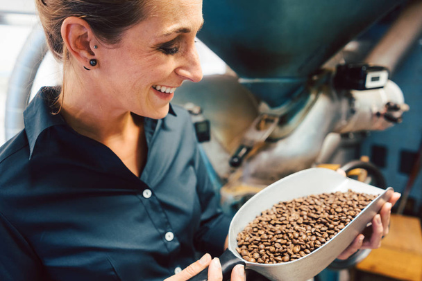 Woman in coffee roastery with fresh beans - Foto, Imagem