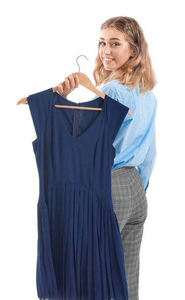 Female worker of modern dry-cleaner with clothes on white background - 写真・画像