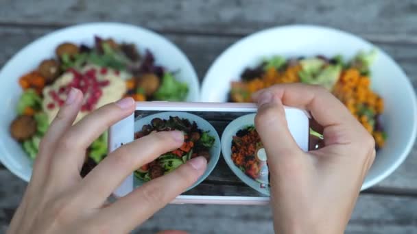 Close-up van handen nemen van foto 's van voedsel in Cafe, Focus op salade kommen in Smartphone Screen - Video
