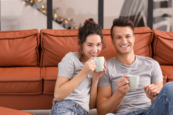 Happy young couple drinking tea at home - Φωτογραφία, εικόνα