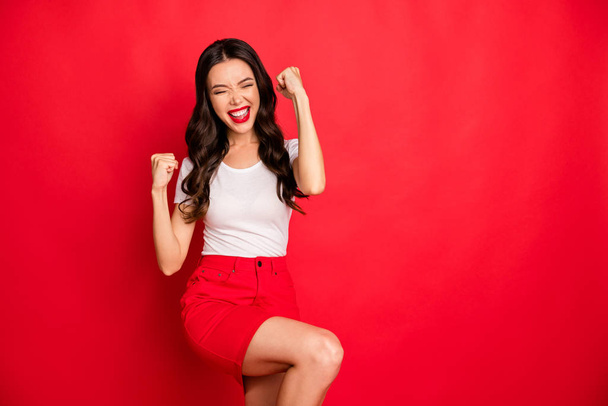 Portrait of her she nice glamorous gorgeous pretty attractive lovely cheerful cheery wavy-haired girl celebrating luck isolated over bright vivid shine vibrant red color background - Foto, Imagem