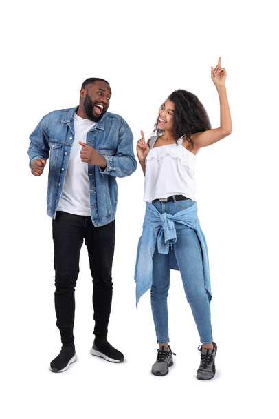 Portrait of young dancing African-American couple on white background - Foto, Bild