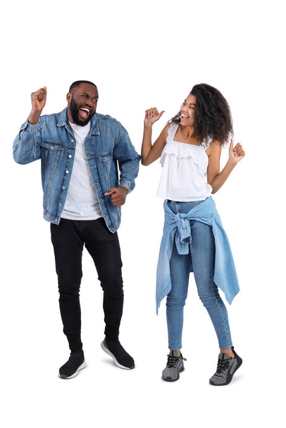 Portrait of young dancing African-American couple on white background - Foto, imagen
