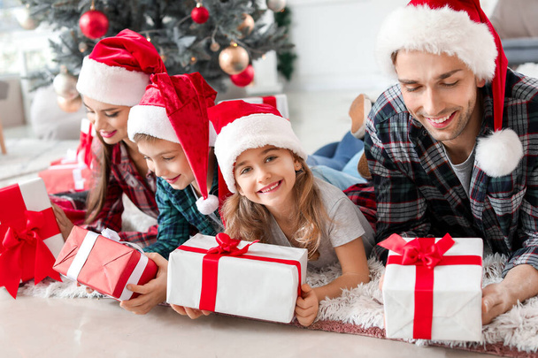 Happy family with Christmas gifts at home - Photo, Image