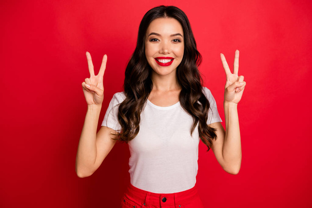 Close-up portrait of her she nice-looking attractive charming cute glamorous lovely cheerful cheery wavy-haired girl showing double v-sign isolated over bright vivid shine vibrant red color background - Foto, afbeelding