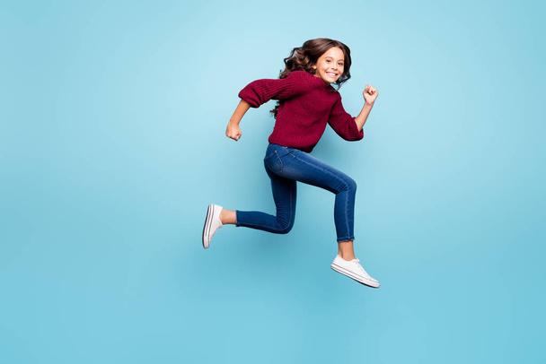 Full length body size side profile photo of wavy cheerful positive girl running towards shopping center footwear isolated over vibrant color blue background - Foto, immagini