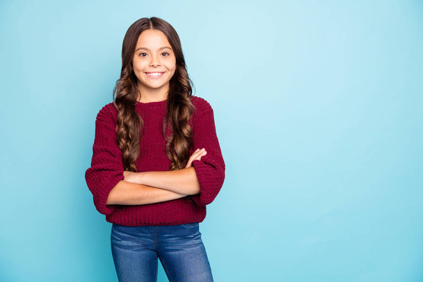 Photo of cheerful positive preteen smiling cheerfully toothily standing confidently with arms crossed isolated blue vivid color background - Photo, image