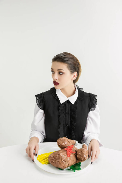 We are what we eat. Womans eating plastic food, eco concept - Фото, зображення