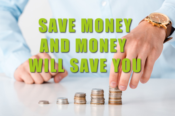 cropped view of man touching stack of coins near save money and money will save you letters on white  - Photo, Image
