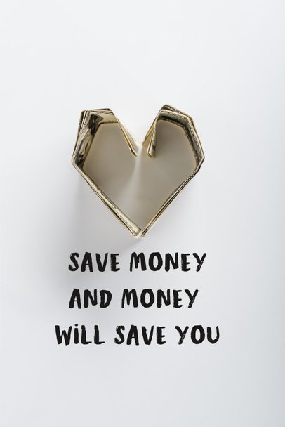 top view of heart-shaped dollar banknotes near save money and money will save you letters on white  - Foto, Bild