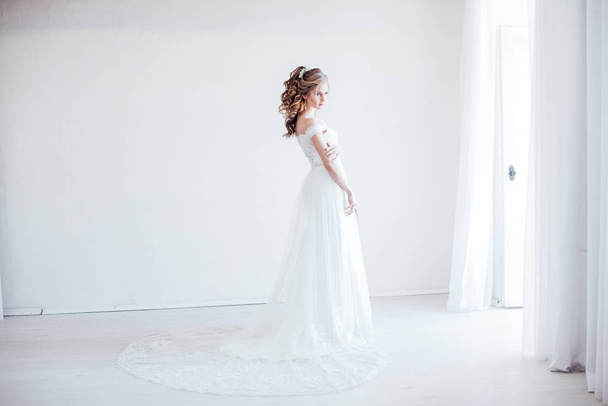 bride in wedding dress in a white room - Photo, image