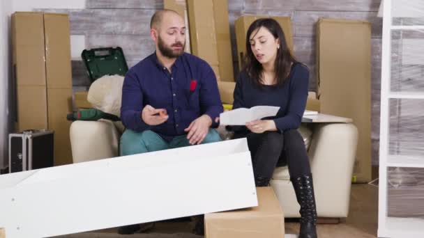 Young couple assembling a shelf as a team - Footage, Video