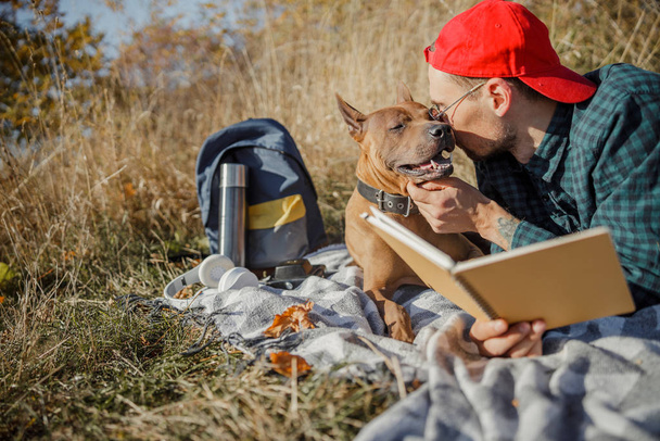 Man whispering kind words to his dog stock photo - Photo, image