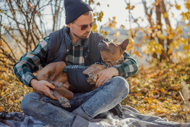 Kind man calming the dog in his arms stock photo - Foto, Imagem