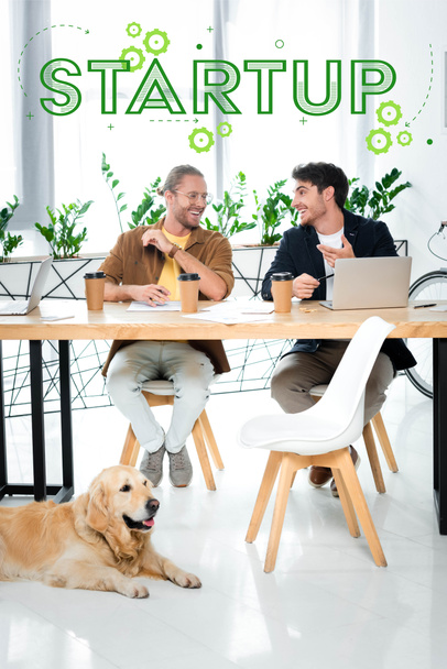 two handsome friends smiling and looking at each other with startup illustration above heads - Photo, Image