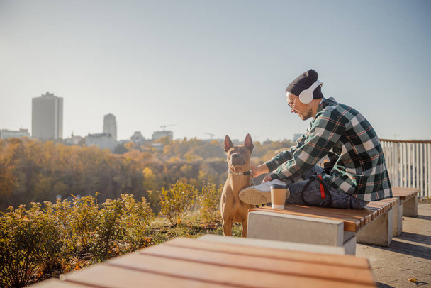 Man smiling to his devoted dog outdoors stock photo - Photo, image