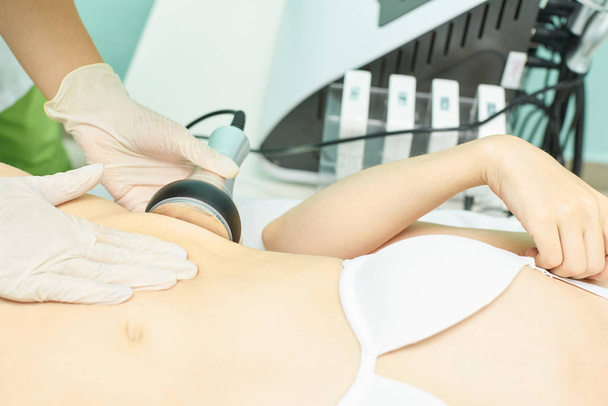 Cavitation rf body treatment. Female ultra sound lipo machine. Spa contouring. Doctor hands - Foto, Imagem