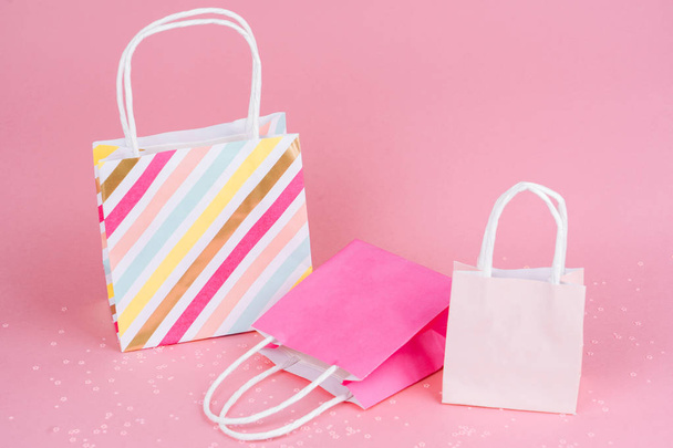 Χαρτοαγορές ή τσάντες δώρων σε ροζ φόντο με αντίγραφο spa � e. - Φωτογραφία, εικόνα