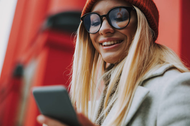 Young woman with modern smartphone smiling wide - Photo, image