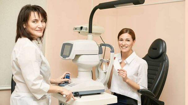 Eye ophthalmologist exam. Eyesight recovery. Astigmatism check concept. Ophthalmology diagmostic device. Beauty girl portrait in clinic - Fotó, kép