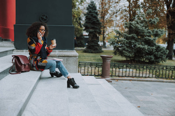 Young Afro American female student talking on smartphone - Valokuva, kuva